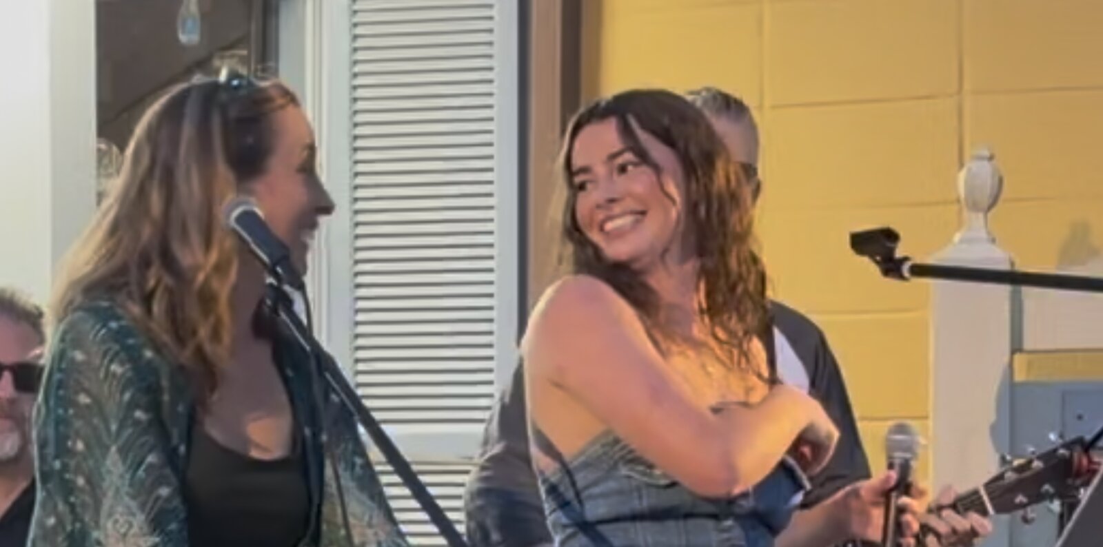 Kailey Jane smiling on stage at GIGS Courtyard in Kensington, Maryland