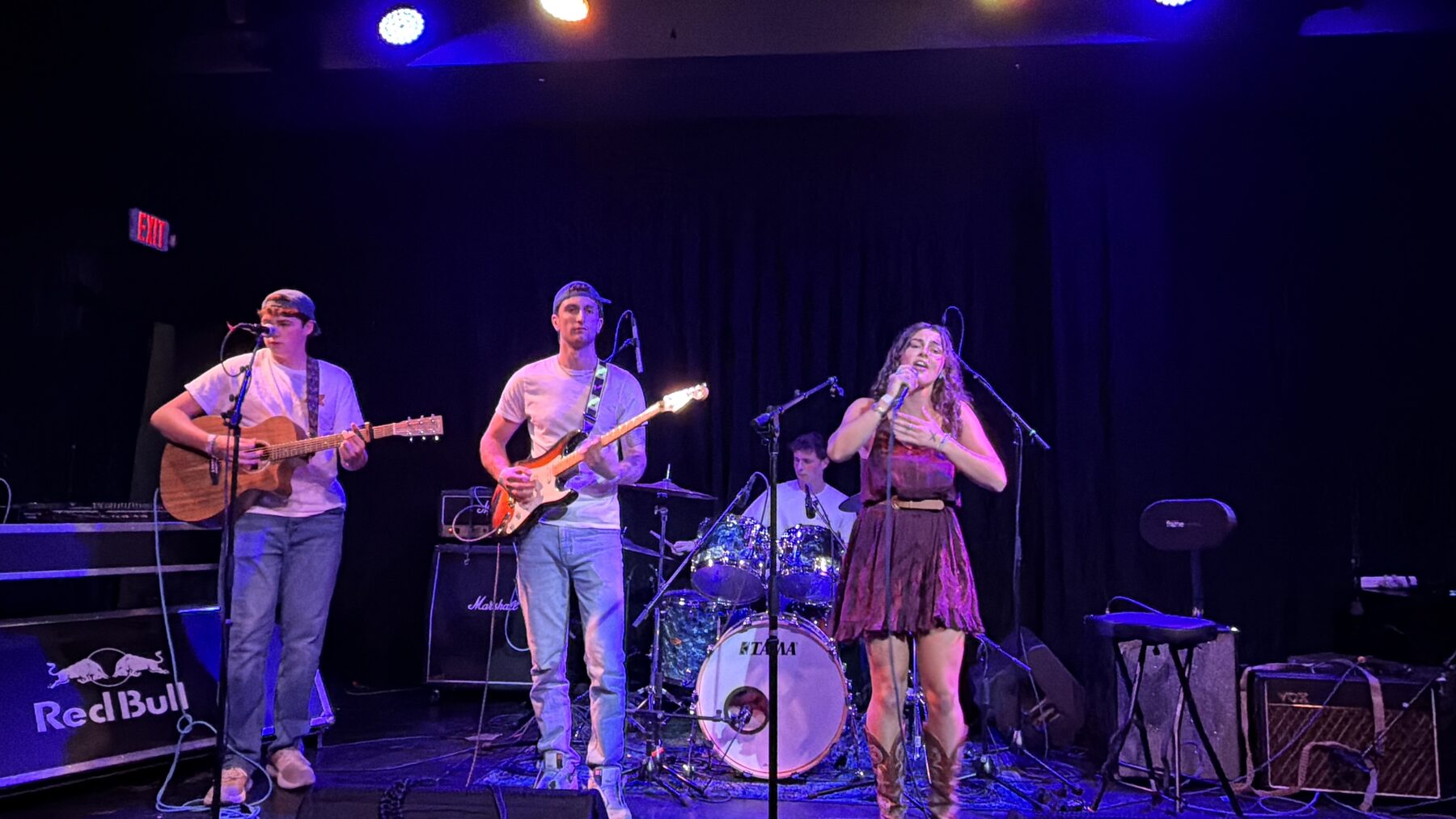 Kailey Jane's band on stage under blue light at Pearl Street Warehouse